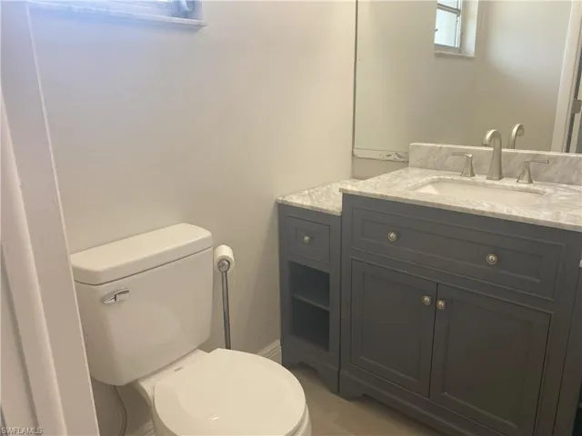 Half bathroom featuring toilet and vanity