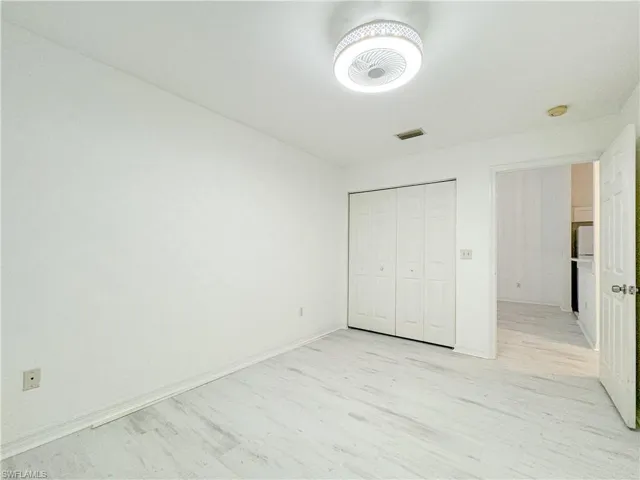 Unfurnished bedroom featuring light hardwood / wood-style floors and a closet