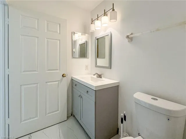 Bathroom with tile patterned flooring, vanity, and toilet