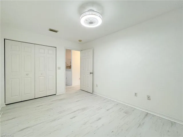 Unfurnished bedroom featuring light wood-type flooring and a closet