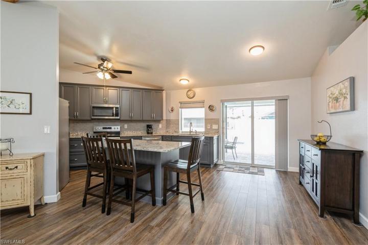 VIEW TO NEWLY RENOVATED KITCHEN AREA WITH ADDED ISLAND AND STILL SPACE FOR A TABLE