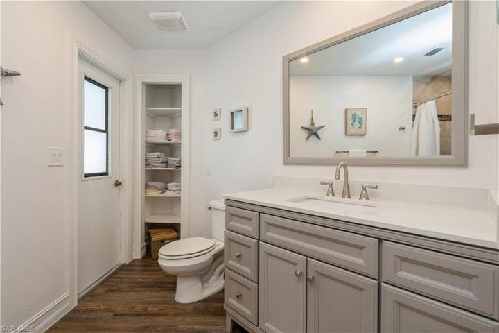 NEWLY RENOVATED PRIMARY BATHROOM WITH DOOR ACCESS TO LANAI AREA