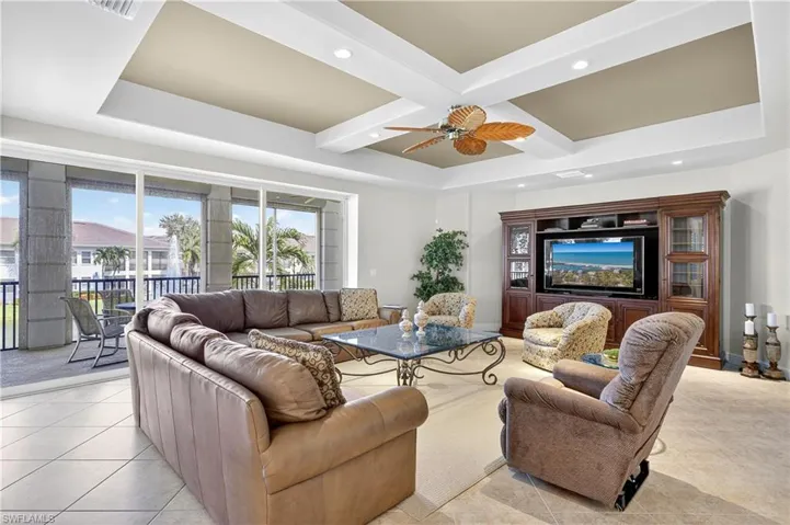 Living room featuring coffered ceiling, recessed lighting, beamed ceiling, light tile patterned flooring, and ceiling fan
