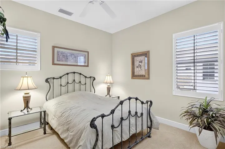 Bedroom featuring light colored carpet and ceiling fan