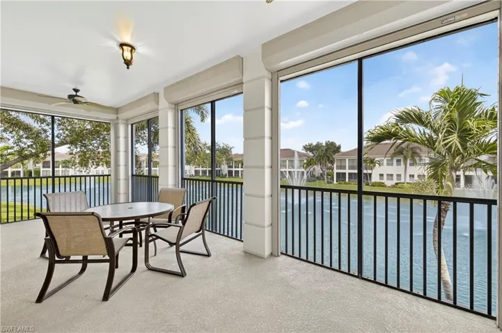 Sunroom with a water view, healthy amount of natural light, and carpet floors