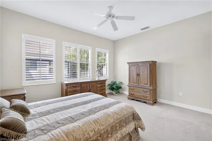 Bedroom featuring light colored carpet and a ceiling fan