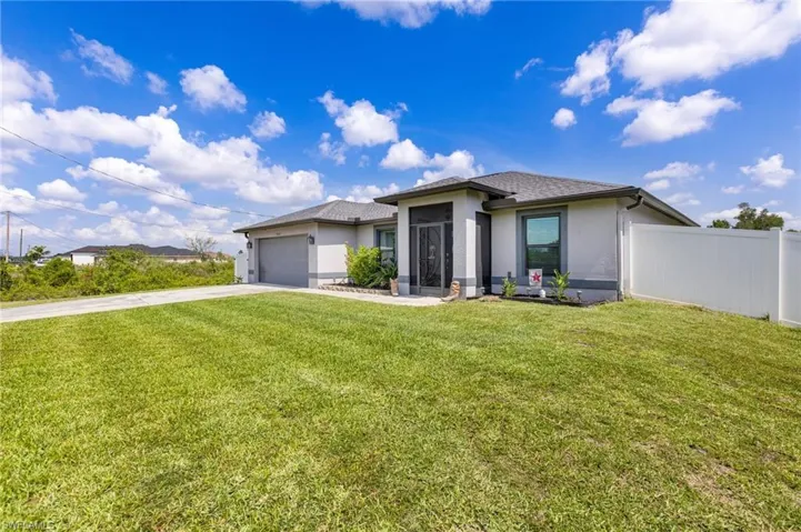 Prairie-style home featuring stucco siding, concrete driveway, and a garage