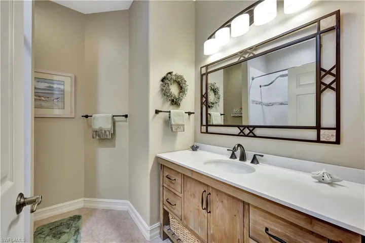 Bathroom featuring a shower, vanity, and tile patterned flooring