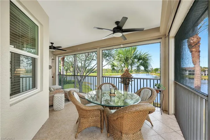 Sunroom / solarium featuring a water view and ceiling fan