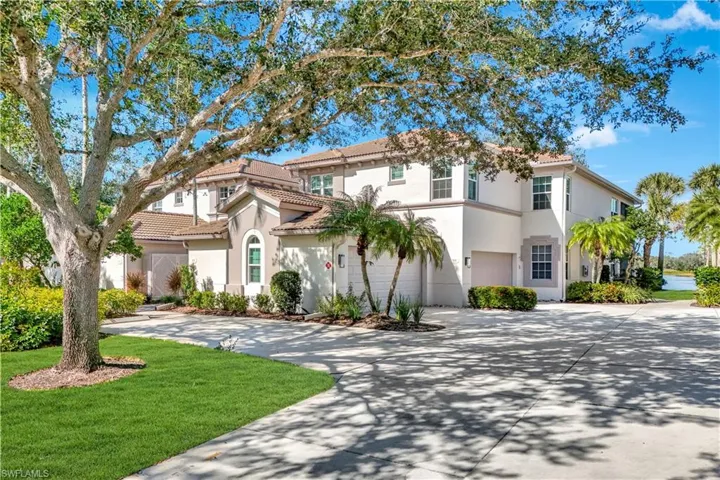 Mediterranean / spanish-style house with a garage and a front lawn