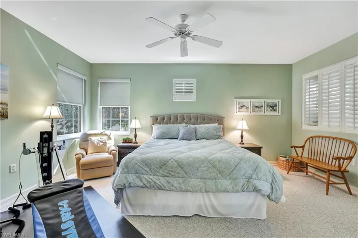 Carpeted bedroom with ceiling fan