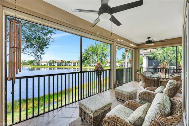 Sunroom with ceiling fan, plenty of natural light, and a water view