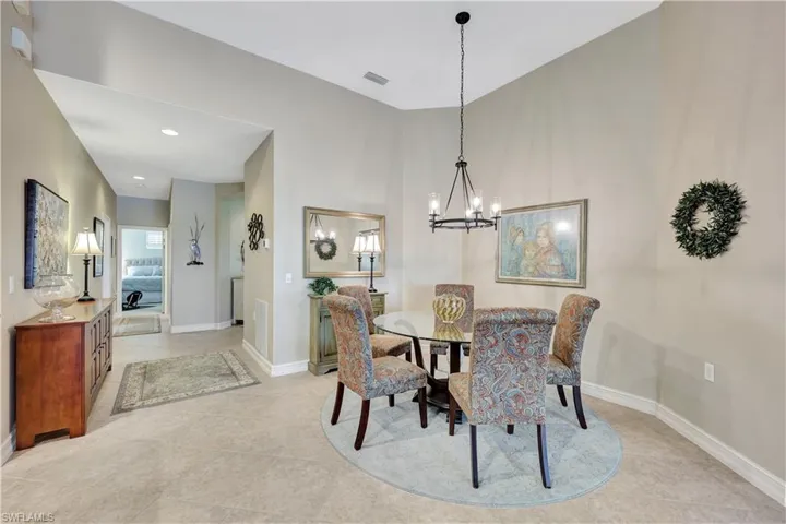 Tiled dining room with a notable chandelier