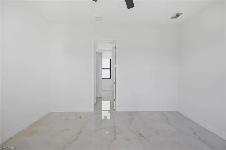 Empty room featuring tile flooring and ceiling fan