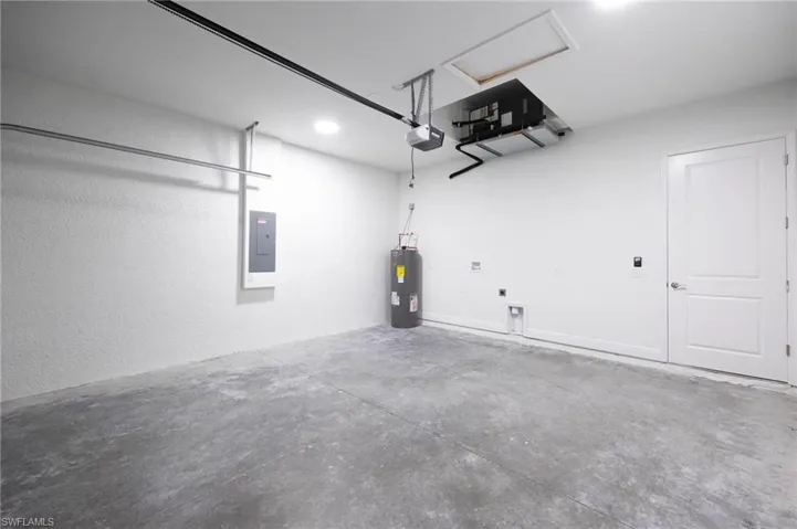 Garage with a garage door opener and electric water heater