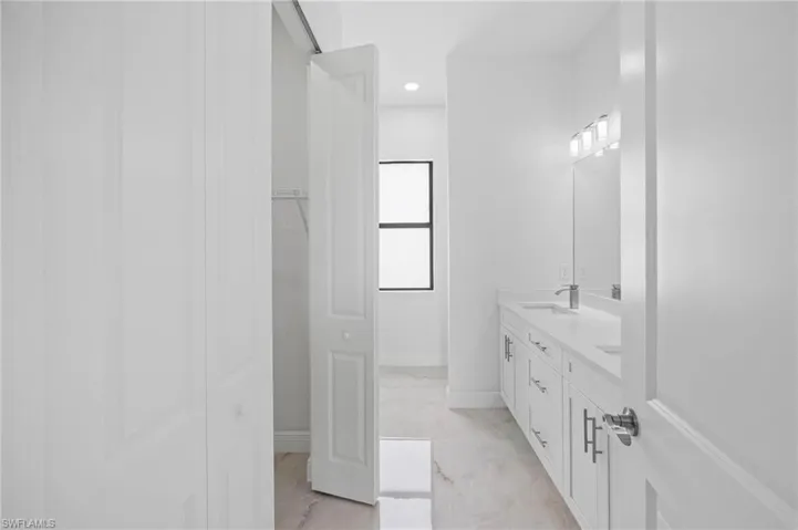 Bathroom featuring tile flooring, double sink, and large vanity