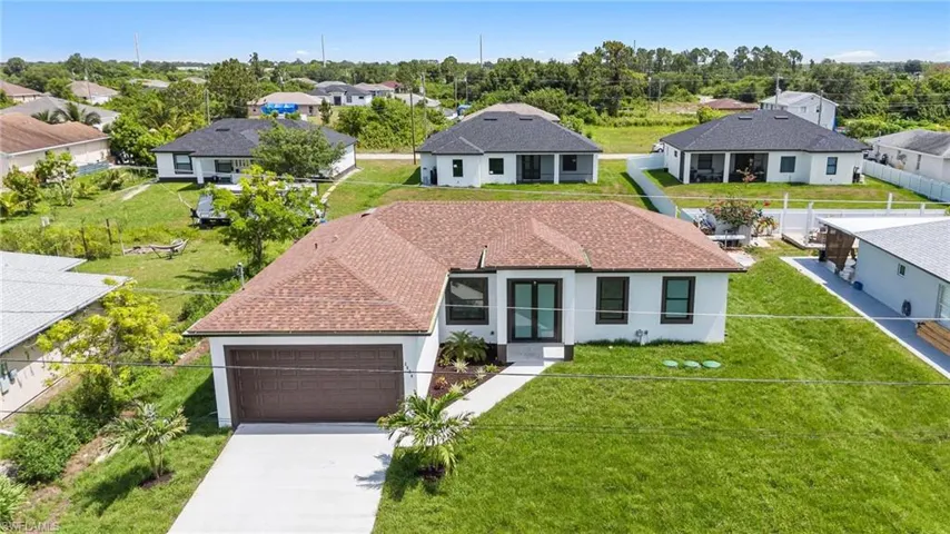 View of front of house with a garage and a front lawn
