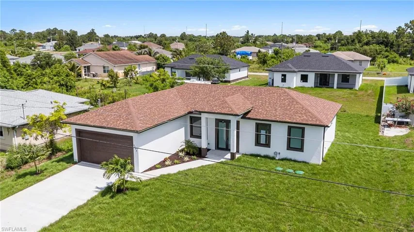 View of front of home with a garage and a front yard