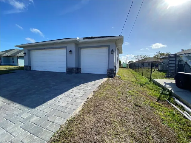 Garage featuring decorative driveway