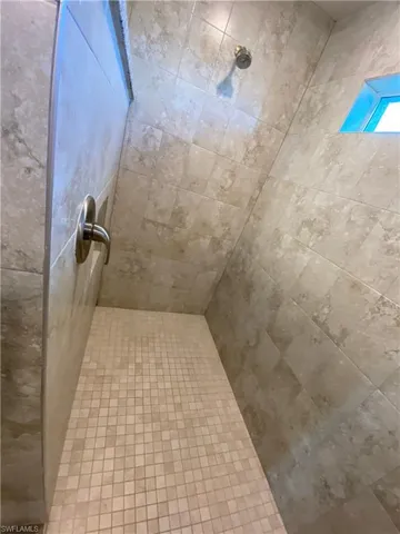 Full bath with a tile shower