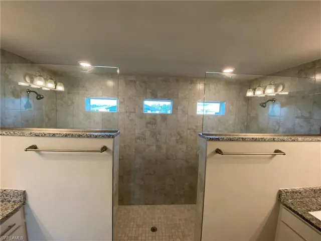 Full bathroom with vanity and walk in shower