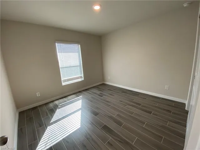 Spare room featuring wood finish floors and recessed lighting
