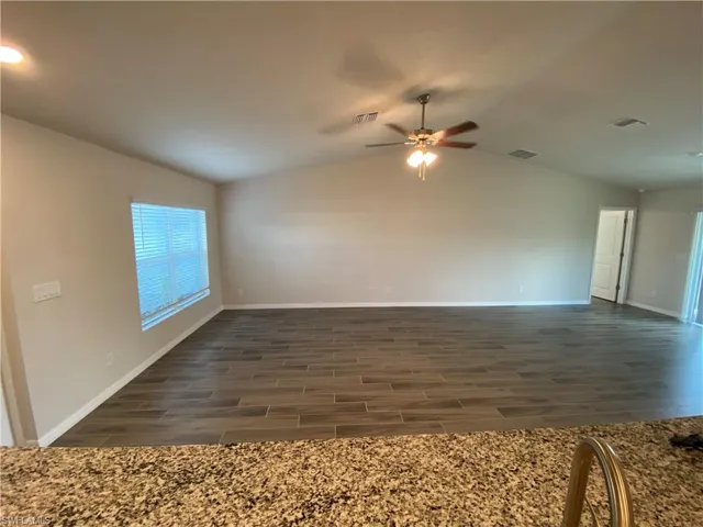 Unfurnished room with wood finish floors and ceiling fan