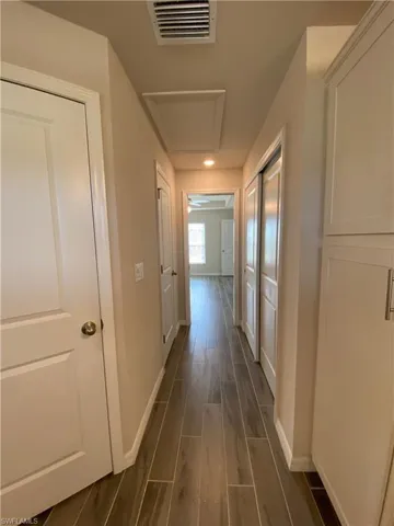Hall with wood finish floors and baseboards