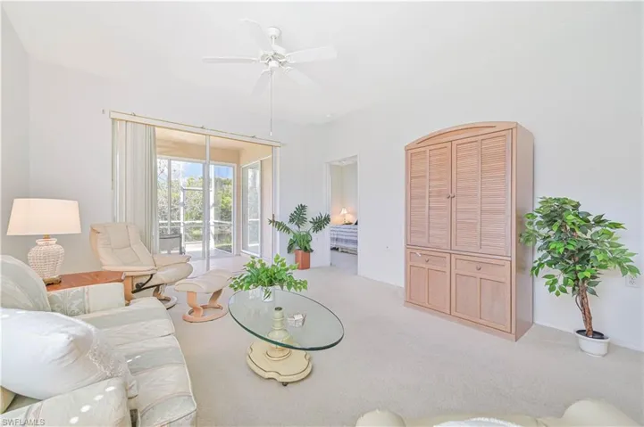 Living room featuring light carpet and ceiling fan