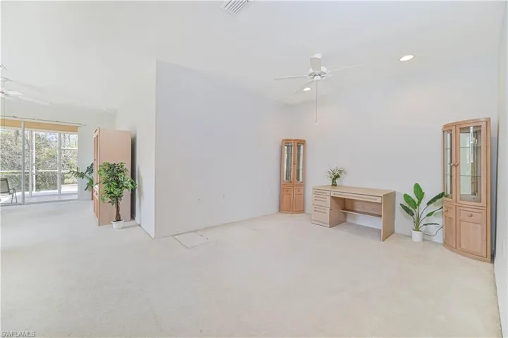 Empty room featuring ceiling fan, light colored carpet, lofted ceiling, and recessed lighting