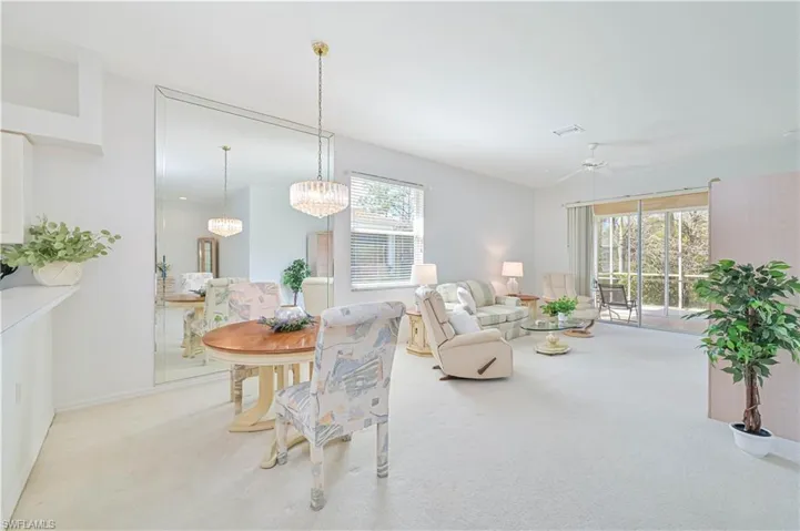 Dining room with light colored carpet and ceiling fan