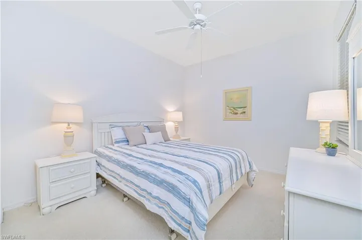 Bedroom featuring light carpet and a ceiling fan