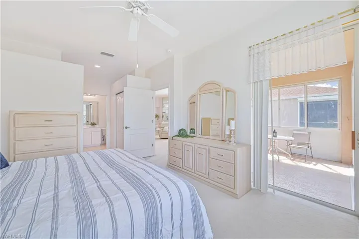 Bedroom with light colored carpet, ceiling fan, and a closet
