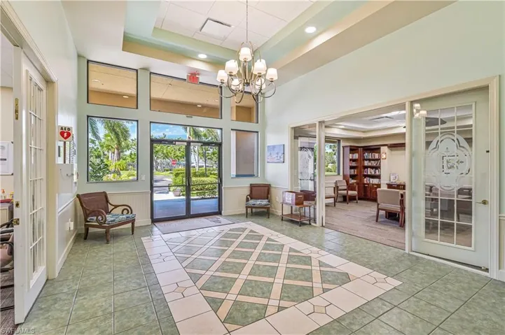 Community lobby featuring a tray ceiling