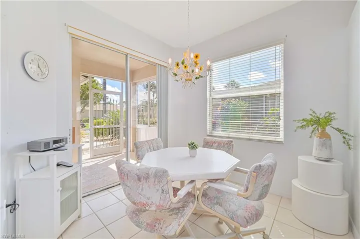 Dining space featuring plenty of natural light, a chandelier, and light tile patterned flooring