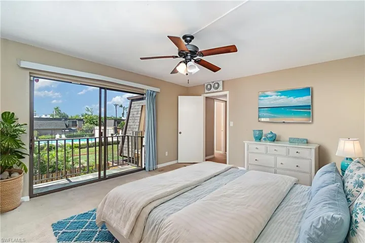 Primary bedroom (check out the view overlooking the pool, super close to the townhome) - Virtually staged