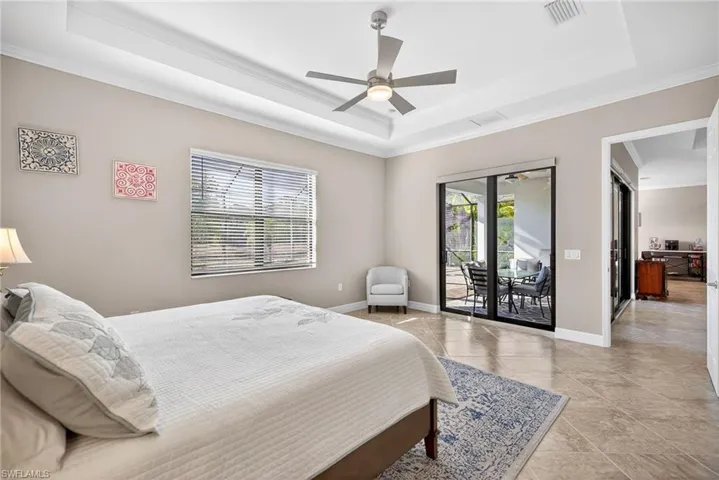 Tiled bedroom with access to exterior, ceiling fan, and crown molding
