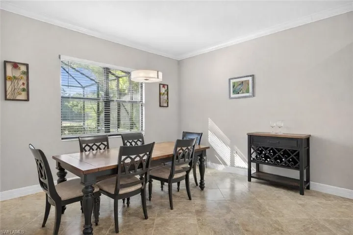 Dining area featuring baseboards and crown molding