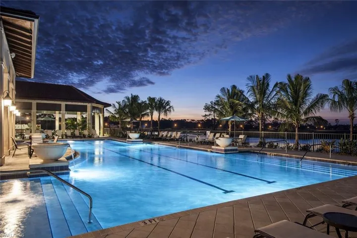 Pool at dusk with a community pool and a patio