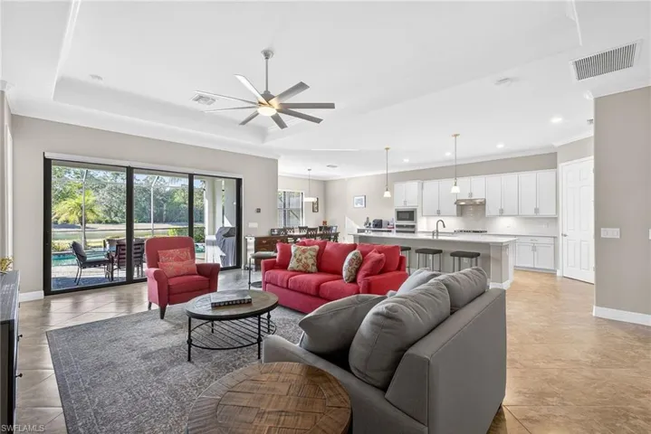 Living area featuring crown molding, ceiling fan, and recessed lighting