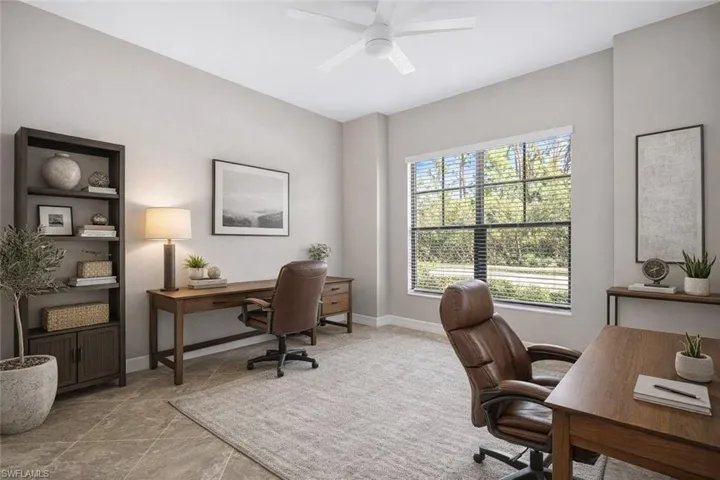 Office area featuring a ceiling fan and baseboards