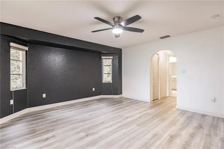 Spare room featuring ceiling fan and light hardwood / wood-style floors