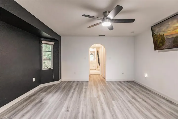 Unfurnished room with ceiling fan and light wood-type flooring