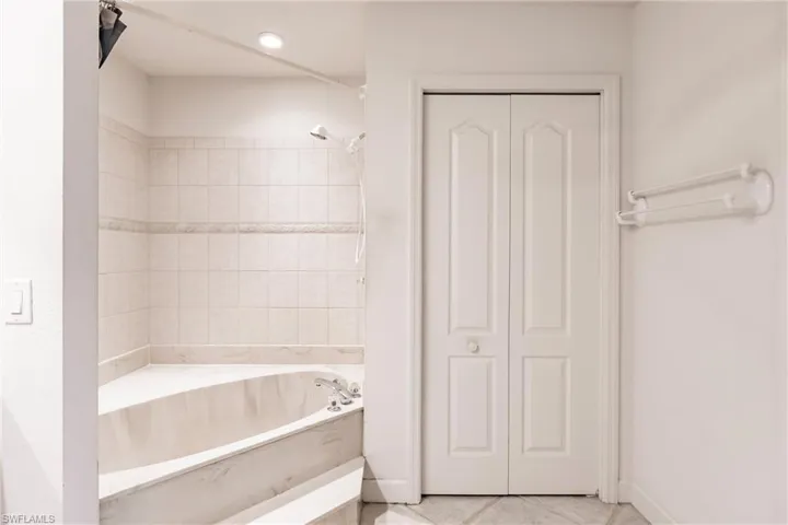 Bathroom with tile floors and a tub