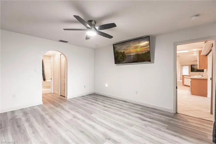 Unfurnished room with ceiling fan and light hardwood / wood-style floors