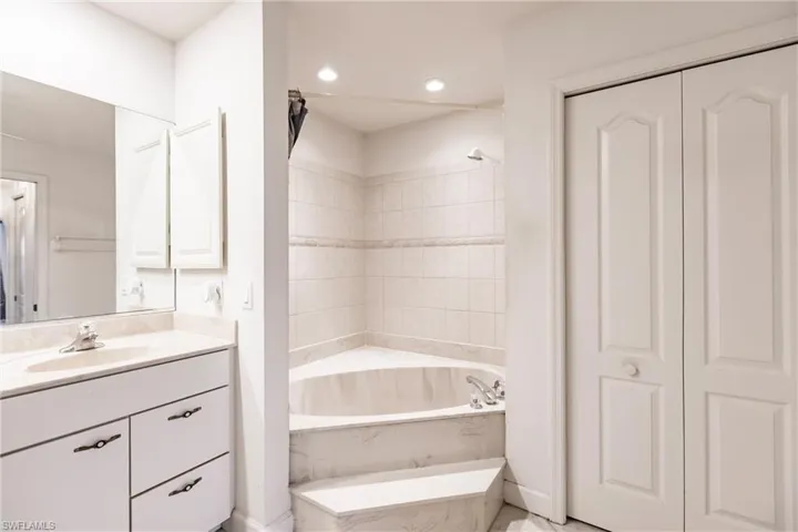 Bathroom featuring vanity and a bath