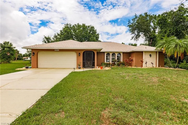 Single story home with a garage and a front yard