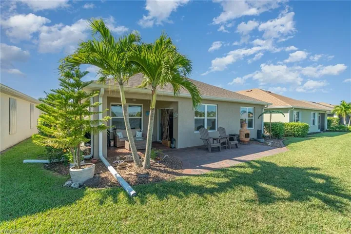 Rear view of house with a yard and a patio area