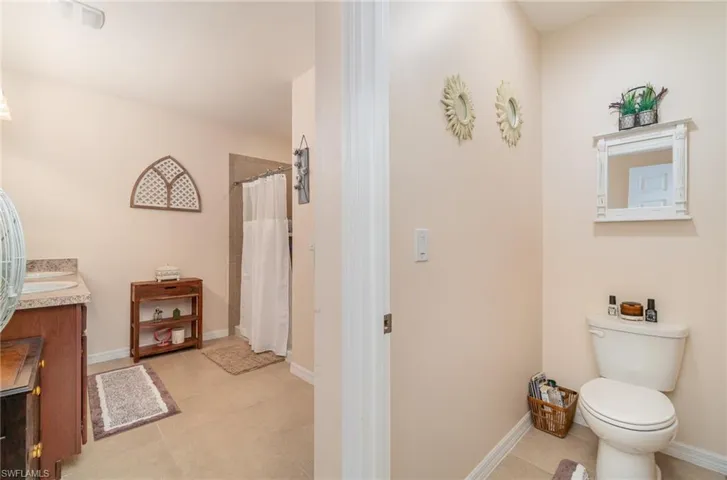 Bathroom featuring vanity, toilet, and tile patterned floors