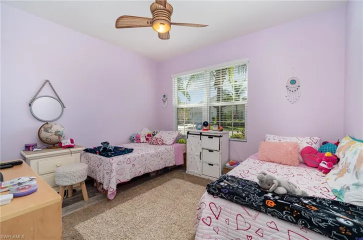 Bedroom featuring ceiling fan and vinyl
